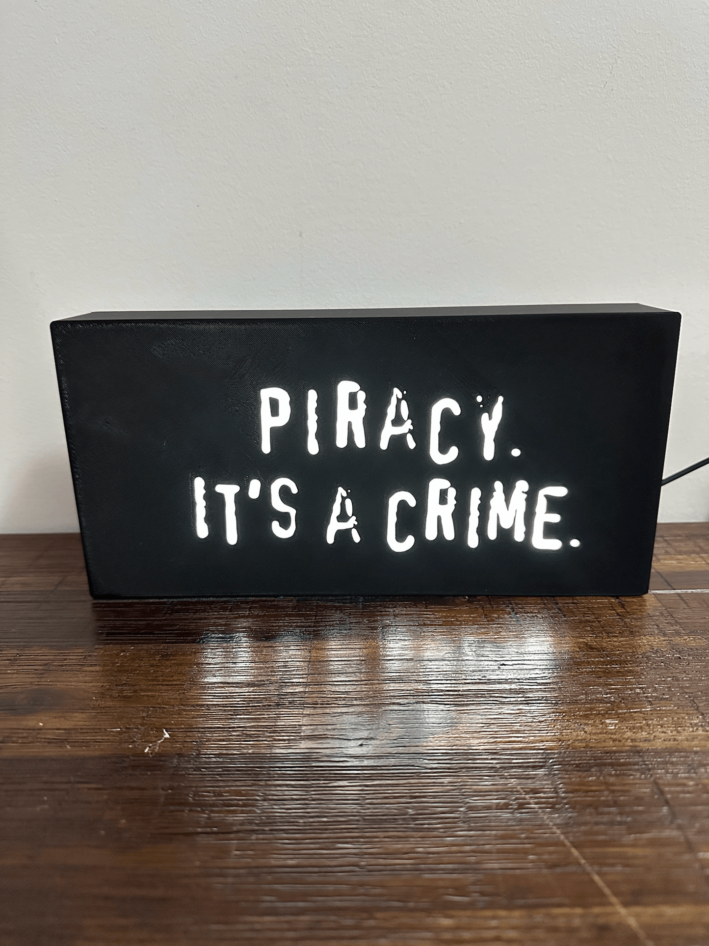 “Piracy. It's a crime” - infamous anti-piracy slogan - light up sign - USB Powered