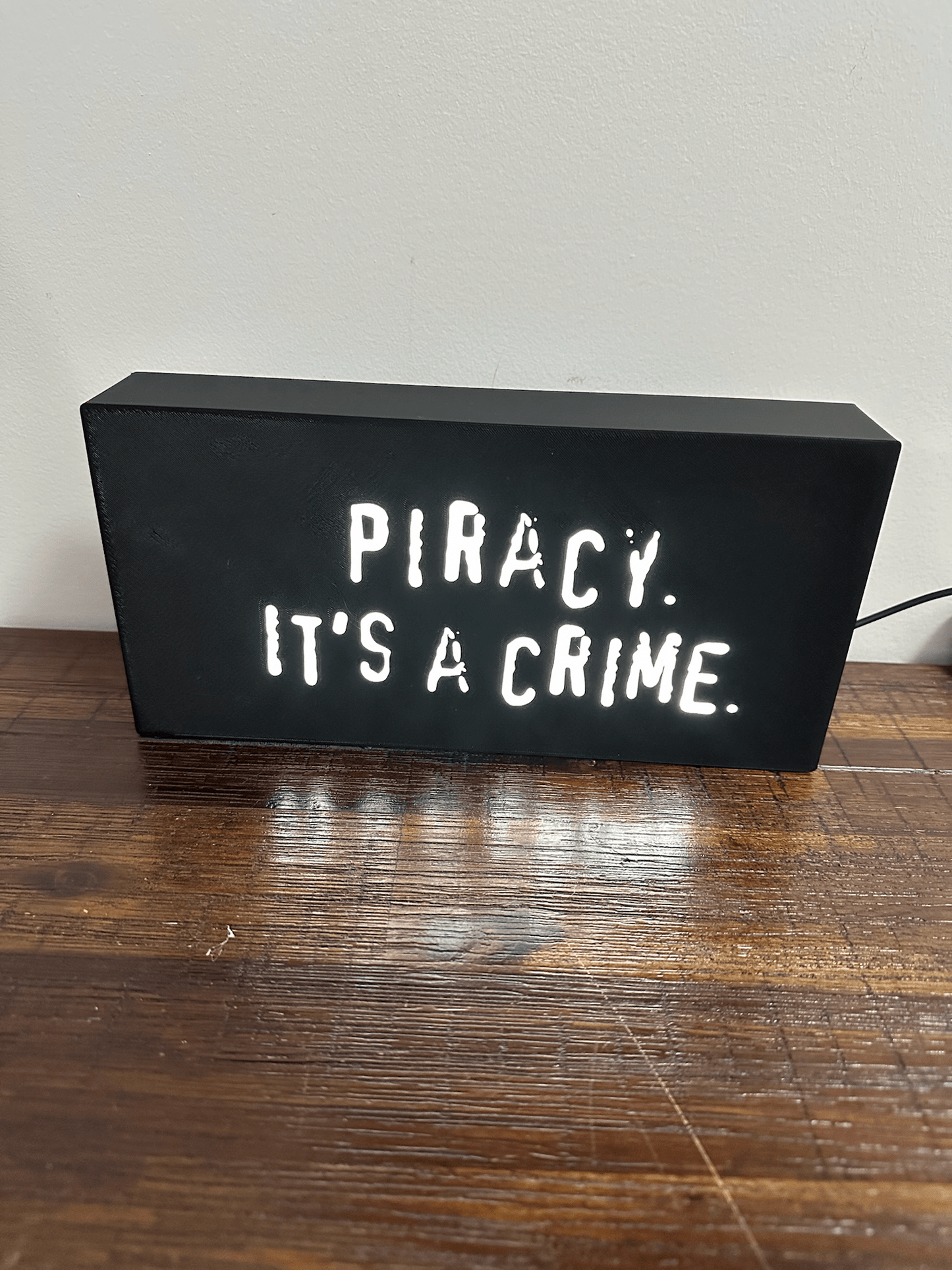 “Piracy. It's a crime” - infamous anti-piracy slogan - light up sign - USB Powered