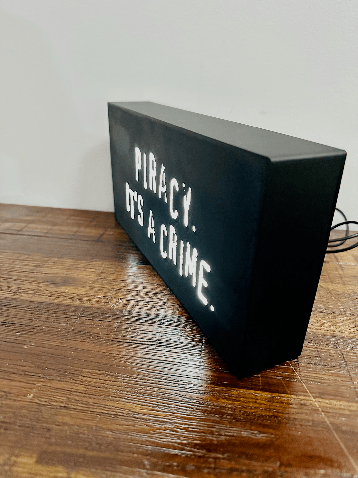 “Piracy. It's a crime” - infamous anti-piracy slogan - light up sign - USB Powered
