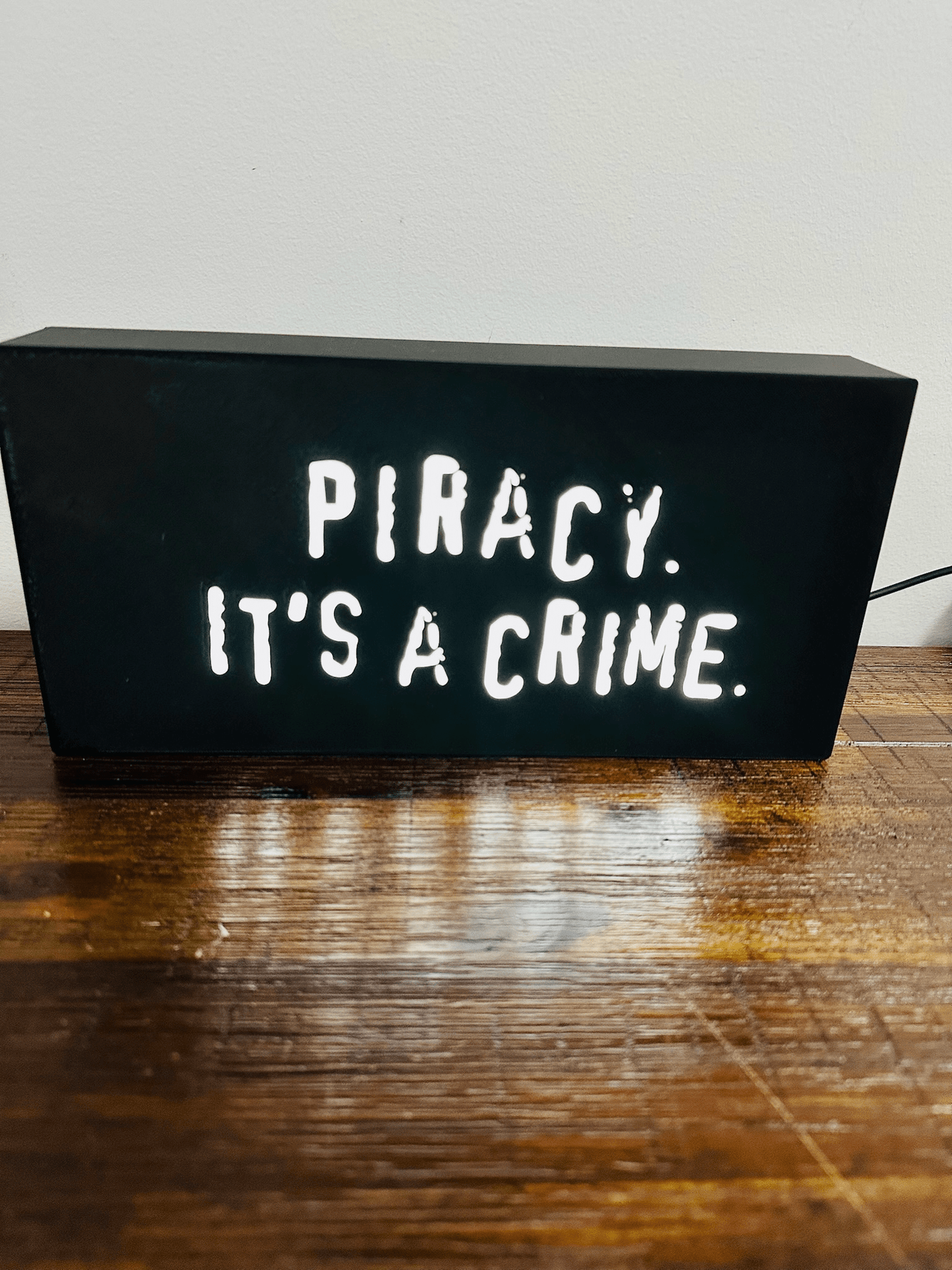“Piracy. It's a crime” - infamous anti-piracy slogan - light up sign - USB Powered
