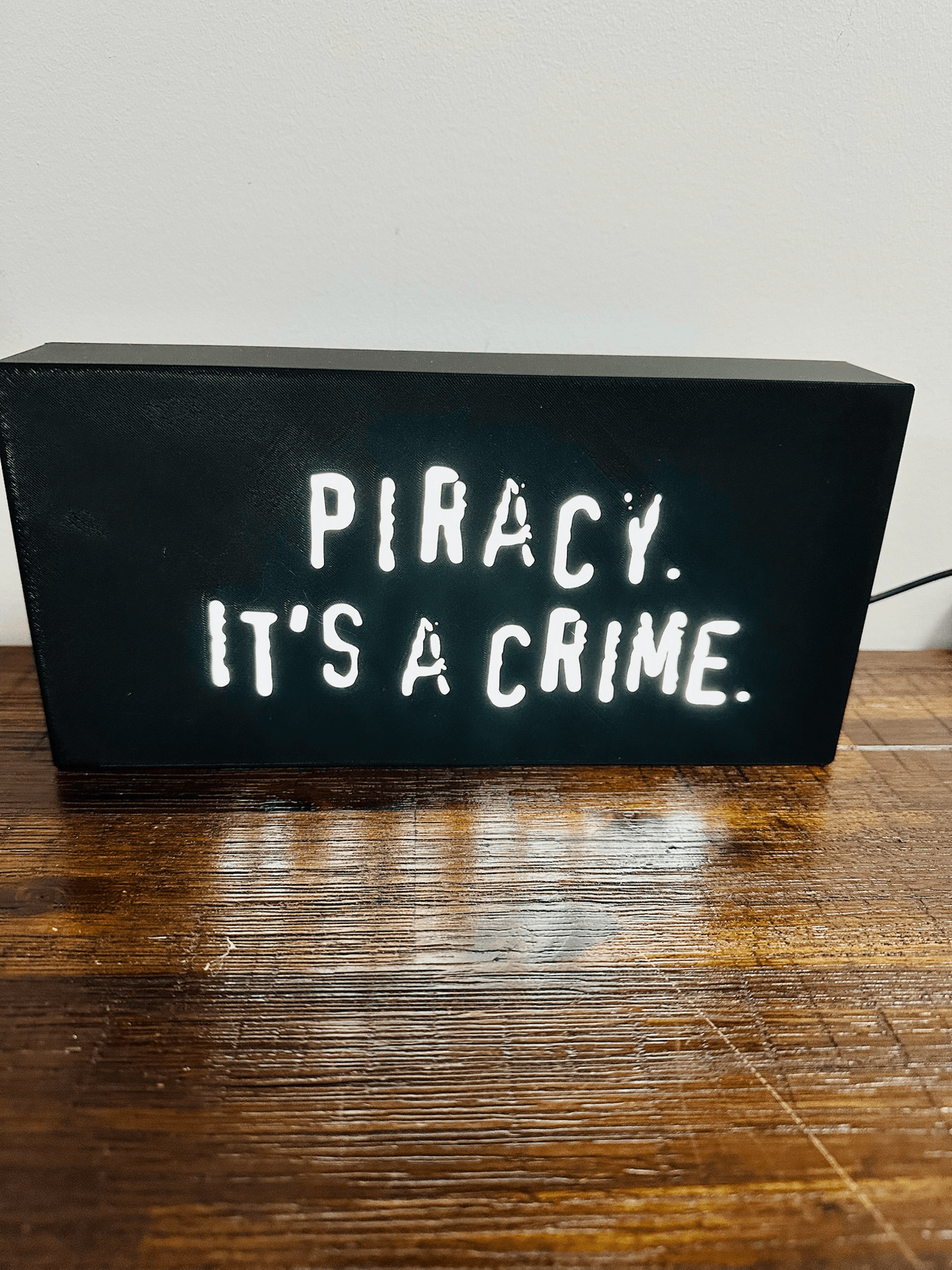 “Piracy. It's a crime” - infamous anti-piracy slogan - light up sign - USB Powered