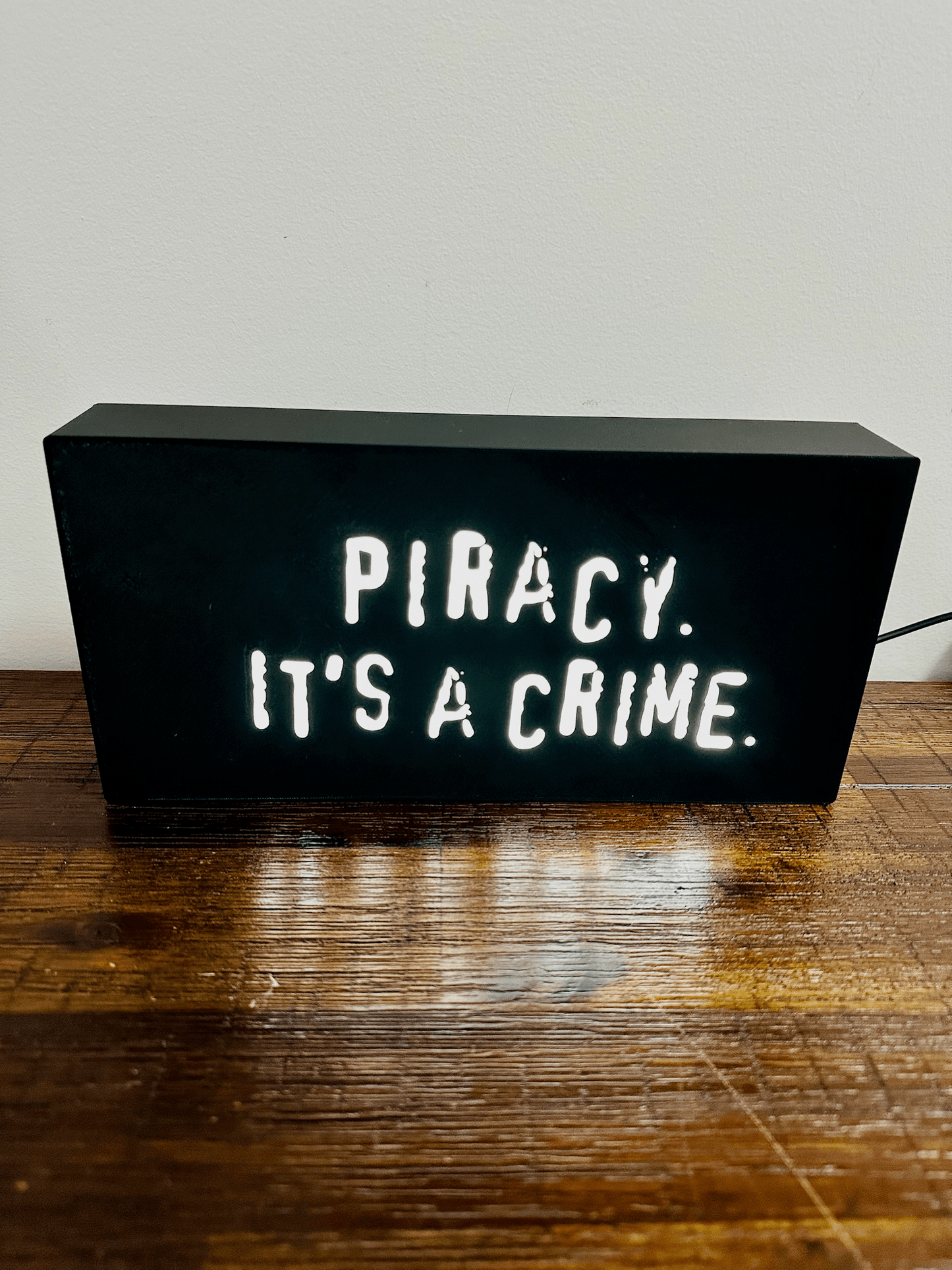 “Piracy. It's a crime” - infamous anti-piracy slogan - light up sign - USB Powered