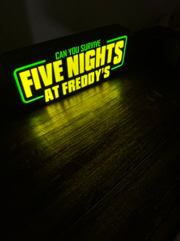 Neon sign with 'Five Nights at Freddy's' text on a dark background