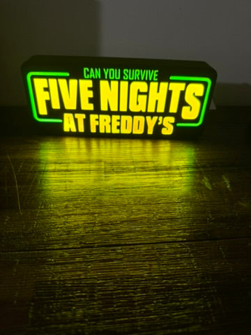 Neon sign with 'Five Nights at Freddy's' text on a dark background
