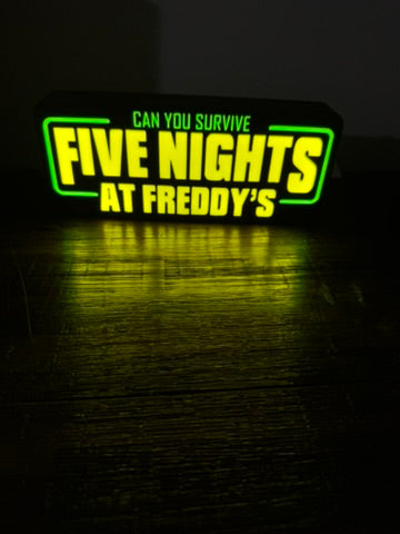 Neon sign with 'Five Nights at Freddy's' text on a dark background
