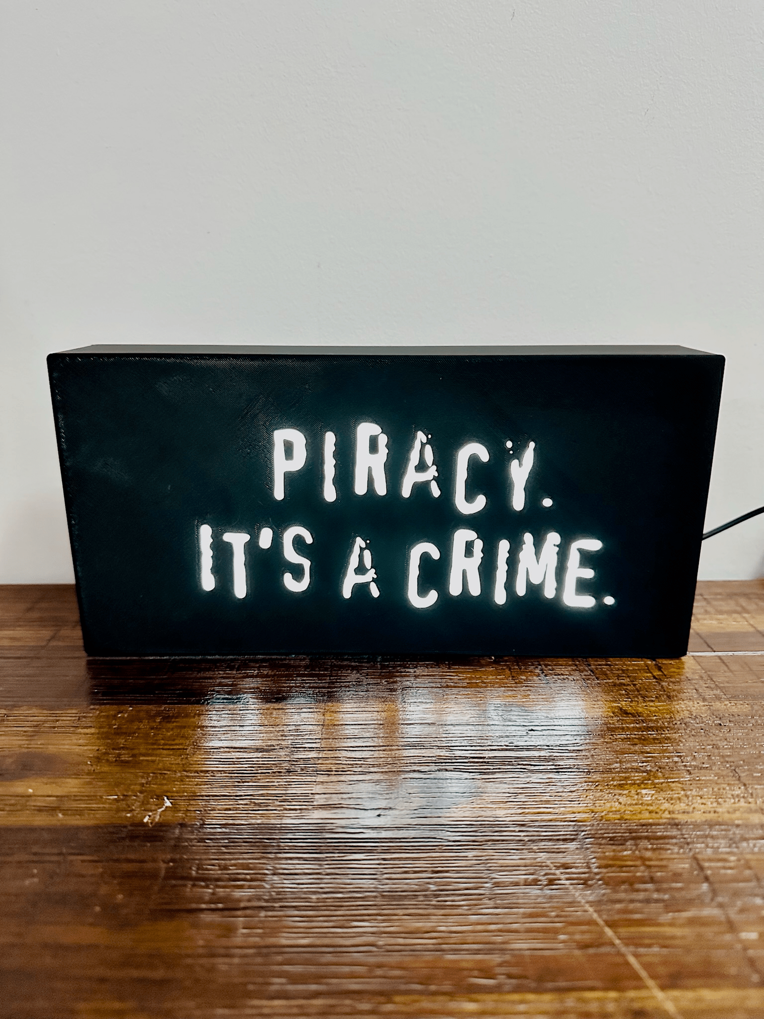 “Piracy. It's a crime” - infamous anti-piracy slogan - light up sign - USB Powered