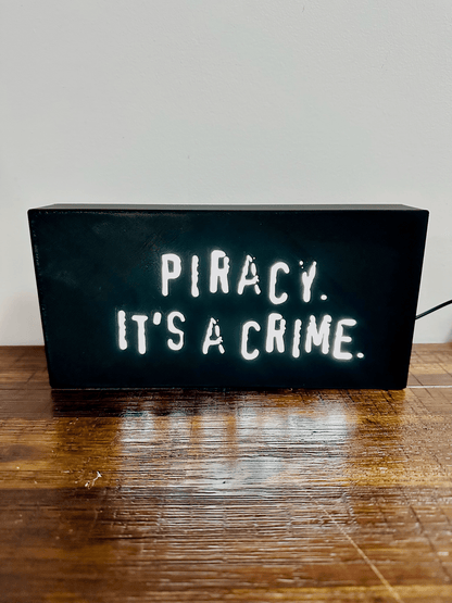 “Piracy. It's a crime” - infamous anti-piracy slogan - light up sign - USB Powered