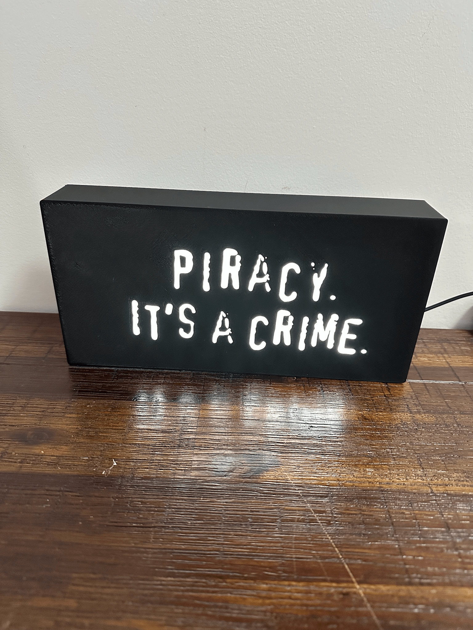 “Piracy. It's a crime” - infamous anti-piracy slogan - light up sign - USB Powered